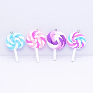 Detail of four colorful resin rainbow lollipop pendants with silver hooks for DIY crafting