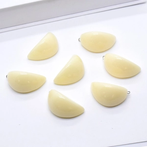 Detailed view of realistic 3D garlic clove resin charms for creative DIY jewelry making