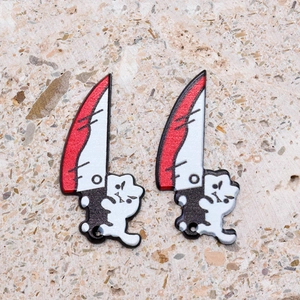Macro shot of acrylic bloody cartoon cat pendants for DIY Halloween jewelry making