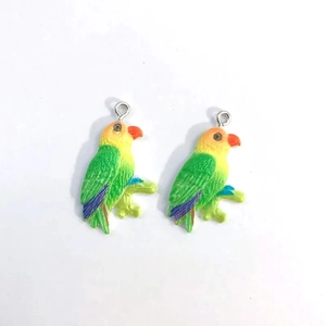 Detail of colorful resin parrot pendants for DIY jewelry making with metal rings