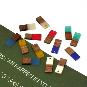 Close-up of colorful resin and wood rectangular charms with pre-drilled holes for DIY jewelry
