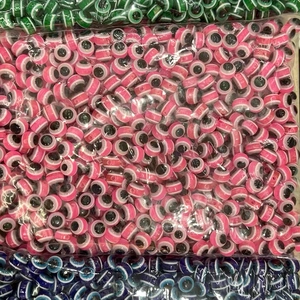 Pink resin evil eye beads for DIY jewelry making in bulk package showing circular design