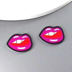 Close-up of pink acrylic pop art lip charms with white teeth for DIY jewelry making