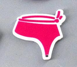 Macro view of a hot pink bikini bottom acrylic charm with bow detail for DIY jewelry