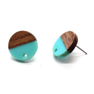 Detail view of round wood and turquoise resin earrings showing natural grain and texture