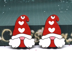 Close-up of laser-cut wooden Christmas gnomes with red heart hats and white beards