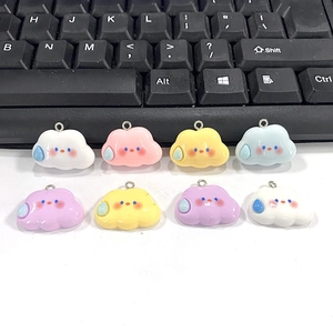 Macro view of colorful cartoon cloud charms with teardrops and metal loops for DIY jewelry
