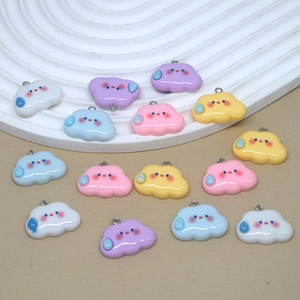 Detail of colorful resin cloud charms with raindrops for DIY jewelry making