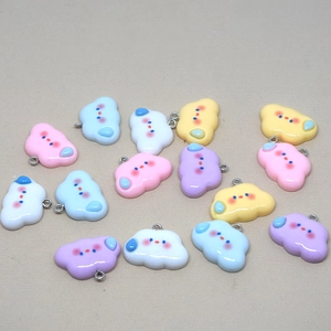 Detail of colorful resin cloud pendants with cute facial expressions for DIY jewelry