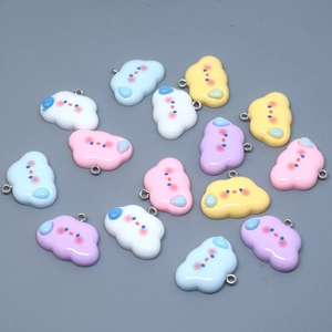 Macro shot of colorful resin cloud pendants with cute expressions for DIY jewelry