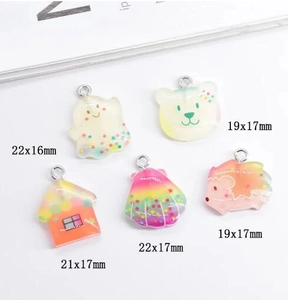 Macro detail of cartoon resin pendants showing sizes and glitter star sequins