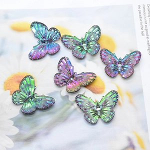Macro view of iridescent butterfly charms with detailed texture for DIY jewelry making