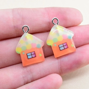 Detail of colorful resin house pendants with polka dot roofs and metal loops for DIY crafts