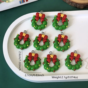Detailed size view of green Christmas wreath charms with red bows for jewelry DIY