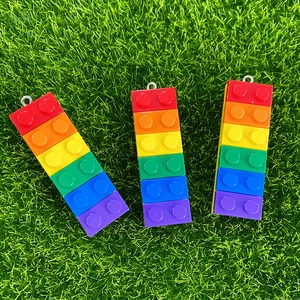 Detailed close-up of rainbow resin building block pendants with colorful segments