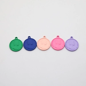 Five assorted colors of Elizabeth II embossed coin pendants for DIY jewelry and crafts