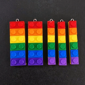 Macro view of rainbow resin building block charms with metal rings for DIY jewelry