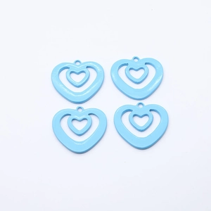 Macro view of four light blue hollow heart alloy charms with triple-layer nested design