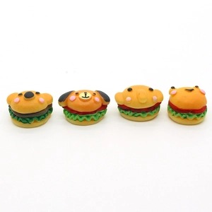 Detailed view of four assorted resin animal burger charms including koala and frog