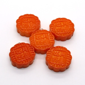 Five orange resin mooncake pendants with floral relief and metal rings for DIY jewelry