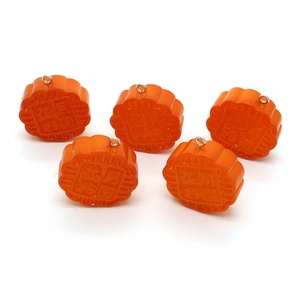 Detail showing five orange resin mooncake charms for DIY jewelry with Chinese engraving