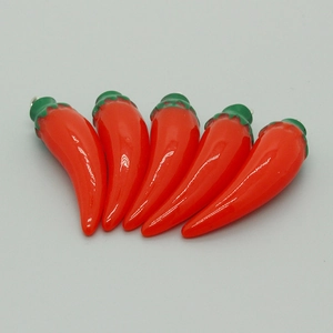 Detailed view of five red resin chili pendants with green stems for DIY jewelry making
