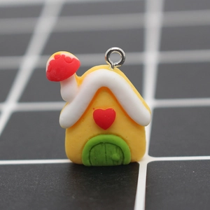 Macro shot of resin house pendant with mushroom chimney and heart detail for DIY crafts