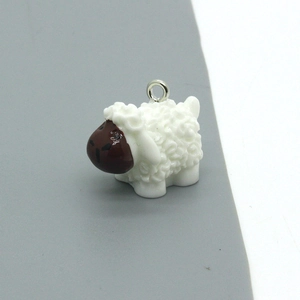 Close-up of cute cartoon sheep pendant with detailed wool texture for DIY jewelry making