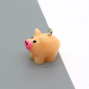 Detail of pink resin pig charm with silver metal loop for DIY jewelry and accessories