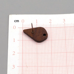Macro view of teardrop dark wood earring post with metal needle for DIY jewelry making