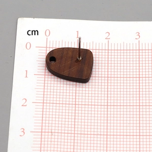 Geometric wood earring studs with metal pins and hanging holes on measurement scale