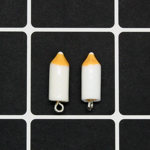 Detail of two resin crayon pendants with silver metal rings for DIY jewelry making