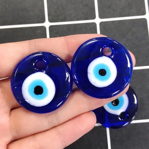Macro shot of glass Evil Eye beads in dark blue for DIY jewelry and necklace making