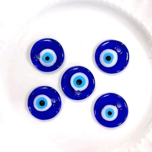 Macro shot of five dark blue glass evil eye charms for DIY jewelry making and crafts
