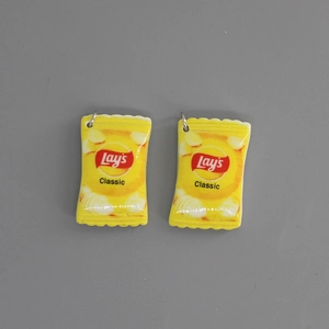 Macro detail of mini resin Lay's classic potato chip pendants for DIY jewelry crafting
