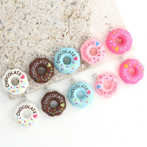 Set of 10 colorful resin donut charms with chocolate lettering and heart accents for DIY