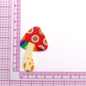 Acrylic mushroom pendant with daisy smiley face and rainbow neck, 5cm size on ruler