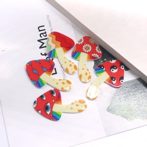Detailed view of colorful acrylic mushroom pendants with psychedelic art for DIY jewelry