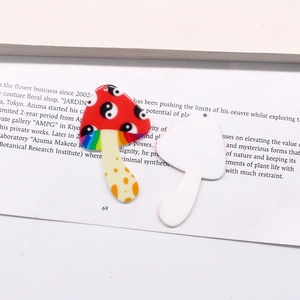 Detailed macro view showing the front and back of mushroom acrylic pendants for DIY jewelry