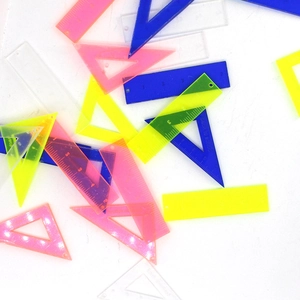 Macro detail of acrylic ruler pendants in neon colors for DIY jewelry and keychains