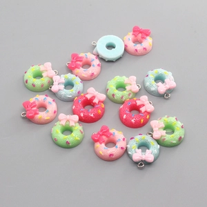 Colorful resin donut pendants with bows and sprinkles for DIY jewelry making