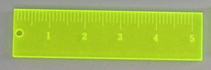 Detail view of a fluorescent yellow acrylic ruler pendant with scale and hanging hole