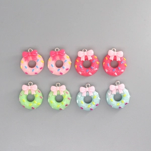Macro detail of resin donut pendants with colorful sprinkles and sweet bow accents