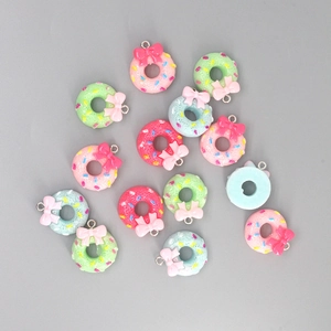 Detailed view of colorful resin donut pendants with bowknots for DIY jewelry making