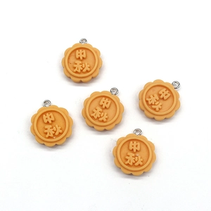 Detail showing resin mooncake pendants with Mid-Autumn festive character and metal rings