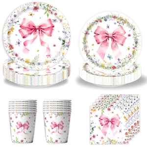 Detail of disposable party paper plates, cups and napkins with pink bow wildflower design