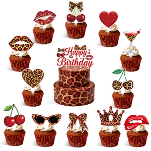 Detail of red leopard print cake toppers set with cherry and bow for birthday party decor