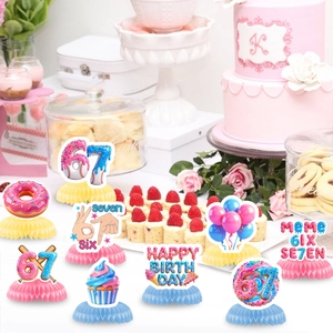 67th Birthday party honeycomb centerpieces with donuts and balloons on dessert table