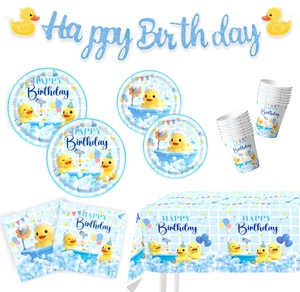 Detail of yellow duck bath theme birthday party supplies with banner plates and napkins