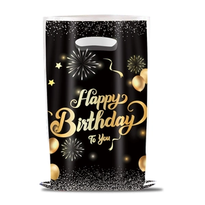 Close-up of black gift bag with gold Happy Birthday To You lettering and festive fireworks